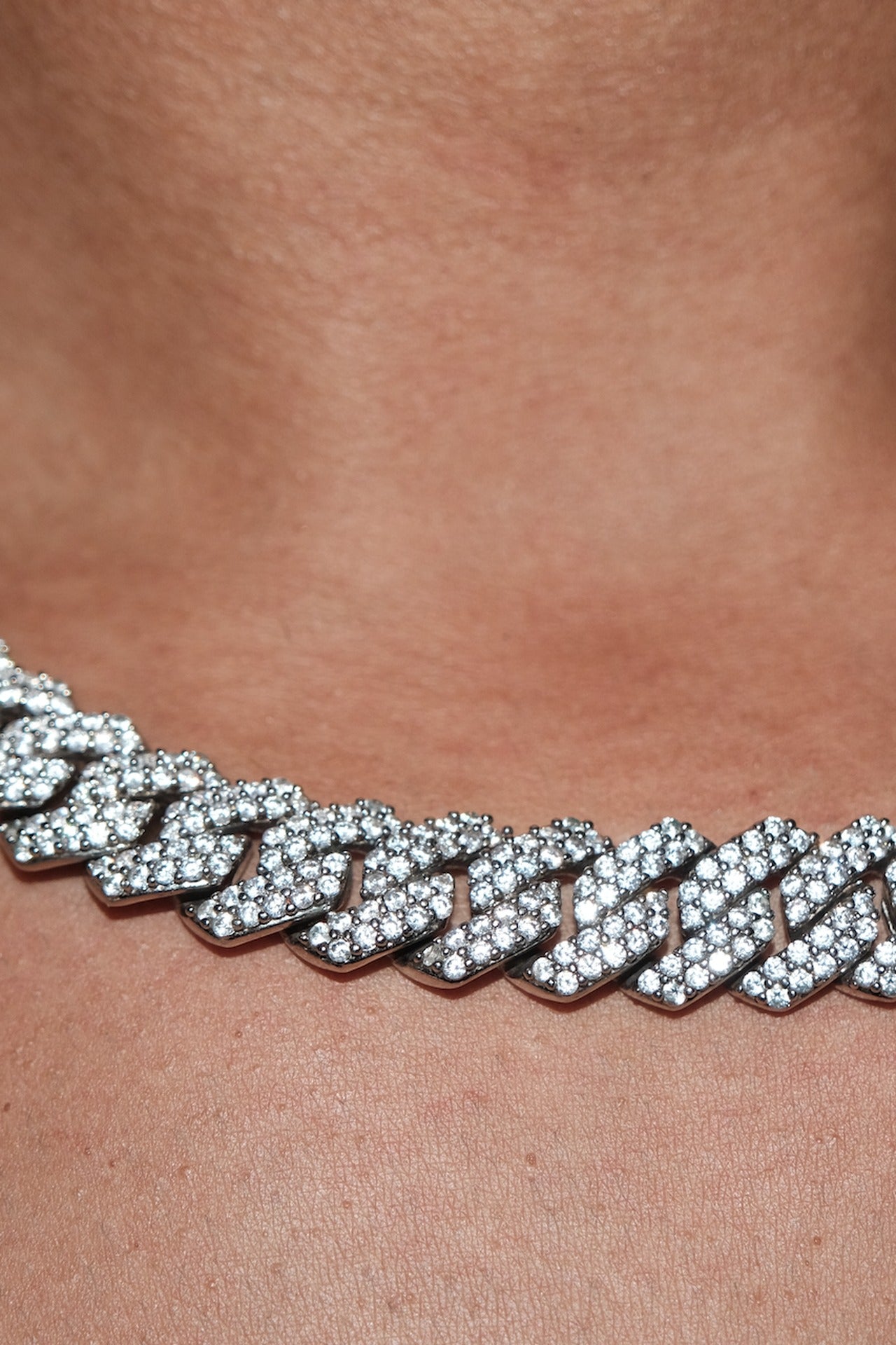 Owner's Crystal Cuban Chain 14mm worn at the collarbone, pave-set cubic zirconia in silver-tone links